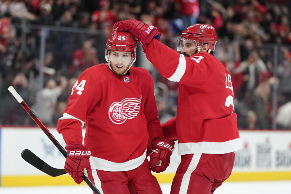 Detroit Red Wings center Pius Suter (24) celebrates his goal with Nick Leddy (2) in the second period of an NHL hockey game against the Chicago Blackhawks Wednesday, Jan. 26, 2022, in Detroit. (AP Photo/Paul Sancya)