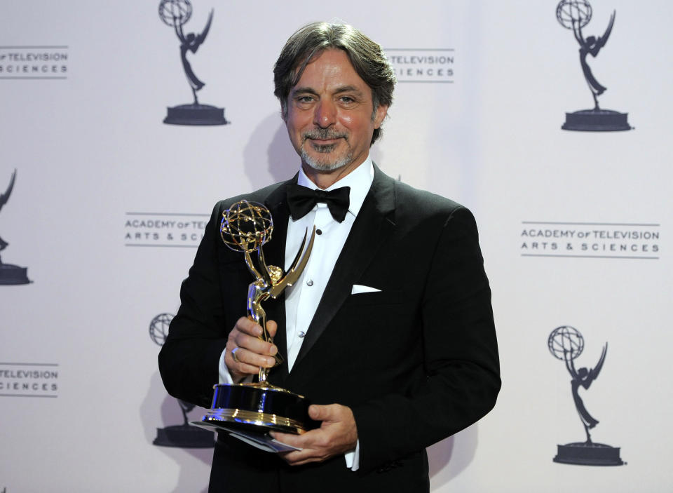 Don Cassidy poses backstage with his award for outstanding single-camera picture editing for a miniseries or a movie for "Hatfields & McCoys - Part 2" at the 2012 Creative Arts Emmys at the Nokia Theatre on Saturday, Sept. 15, 2012, in Los Angeles. (Photo by Chris Pizzello/Invision/AP)
