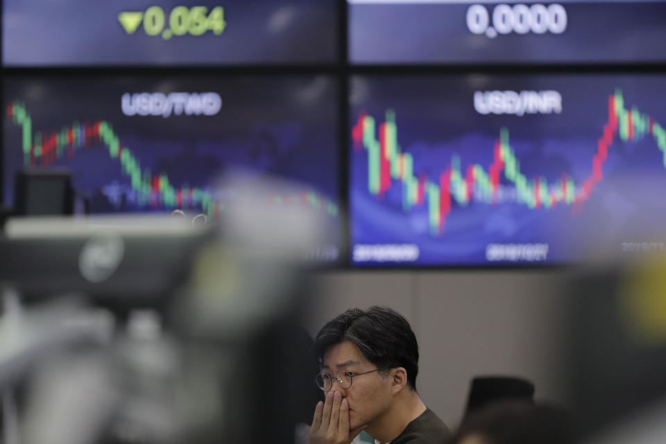 A currency trader watches computer monitors at the foreign exchange dealing room in Seoul, South Korea, Friday, Nov. 29, 2019. Shares extended losses in Asia on Friday after Japan and South Korea reported weak manufacturing data that suggest a worsening toll from trade tensions. (AP Photo/Lee Jin-man)