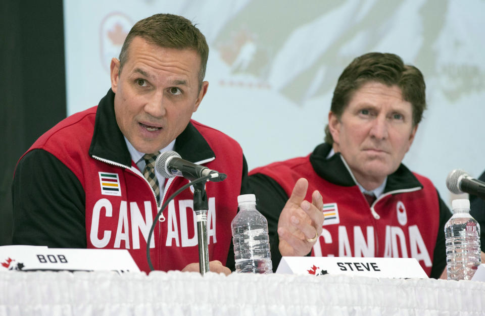 Team Canada general manager Steve Yzerman, left, speaks following the announcement of the team's Olympic men's hockey roster as head coach Mike Babcock listens during a news conference in Toronto, Tuesday, Jan. 7, 2014. (AP Photo/The Canadian Press, Mark Blinch)