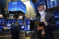 In this photo provided by the New York Stock Exchange, trader Neil Catania works on the trading floor, Tuesday, Dec. 1, 2020. U.S. stocks rose broadly in morning trading Tuesday, sending the S&P 500 toward another record high, as investors focus on the possibility that coronavirus vaccines could soon help usher in a fuller global economic recovery. (Colin Ziemer/New York Stock Exchange via AP)
