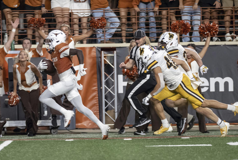 Texas receiver Xavier Worthy, left, runs for a receiving touchdown during the second half of the team's NCAA college football game against Wyoming, Saturday, Sept. 16, 2023, in Austin, Texas. (AP Photo/Michael Thomas)