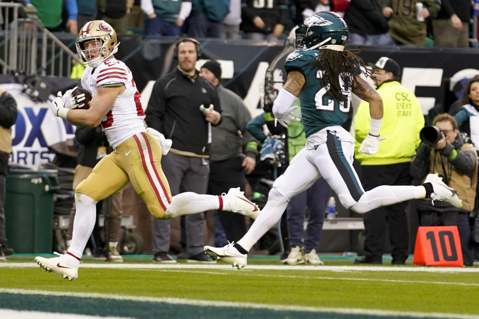 San Francisco 49ers running back Christian McCaffrey, left, scores past Philadelphia Eagles cornerback Avonte Maddox during the first half of the NFC Championship NFL football game between the Philadelphia Eagles and the San Francisco 49ers on Sunday, Jan. 29, 2023, in Philadelphia. (AP Photo/Seth Wenig)