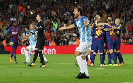 Soccer Football - La Liga Santander - FC Barcelona vs Malaga CF - Camp Nou, Barcelona, Spain - October 21, 2017 Barcelona’s Gerard Deulofeu celebrates scoring their first goal with team mates as Malaga players appeal to the referee REUTERS/Albert Gea