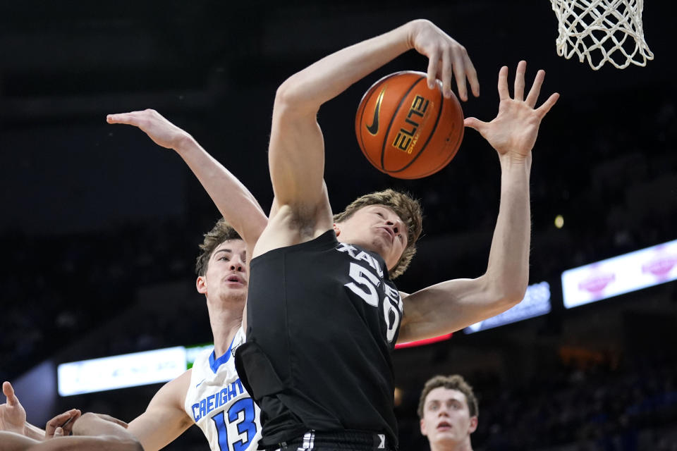 Xavier forward Gytis Nemeiksa (50) fights for a rebound with Creighton forward Mason Miller (13) during the first half of an NCAA college basketball game, Tuesday, Jan. 23, 2024, in Omaha, Neb. (AP Photo/Charlie Neibergall)