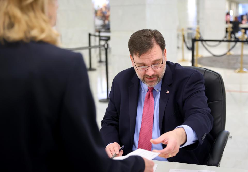 Paul Ziriax, state election board secretary, registers a candidate during 2024 candidate filing Wednesday at the state Capitol.