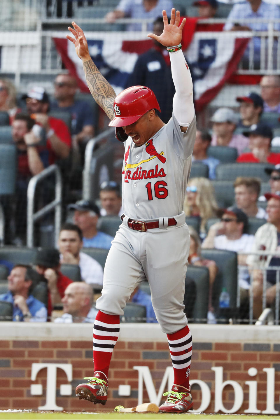 St. Louis Cardinals' Kolten Wong celebrates after scoring on a wild pitch by Atlanta Braves pitcher Max Fried during the first inning of Game 5 of their National League Division Series baseball game Wednesday, Oct. 9, 2019, in Atlanta. (AP Photo/John Bazemore)