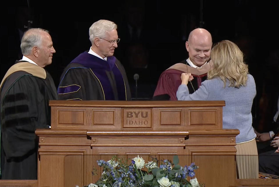 Jennifer Meredith places a medallion around the neck of her husband, new BYU-Idaho President Alvin F. Meredith on Oct. 10, 2023.