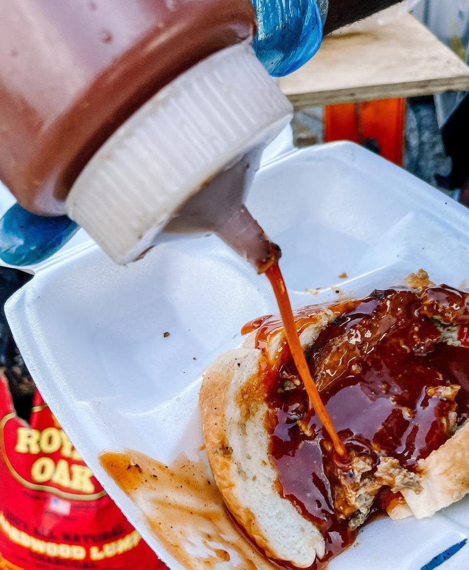 Wholly Souled Soul Food makes its own seasoning and barbecue sauce. The sauce is sweet and tangy, and customers have asked to buy it. Fountain City, Aug. 25, 2022. Pictured here finishing off a plate of smoked meatloaf.