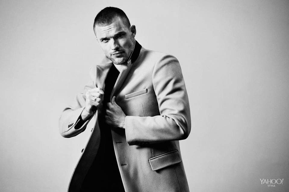 Ed Skrein wears a Rogue t-shirt underneath his coat.