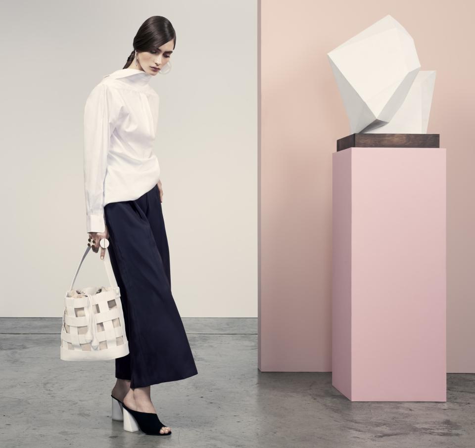 Model carries the Manacor Bag in white