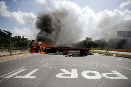 A truck set on fire at a highway during a rally against Venezuela's President Nicolas Maduro's Government in Caracas, Venezuela, June 23, 2017. REUTERS/Ivan Alvarado