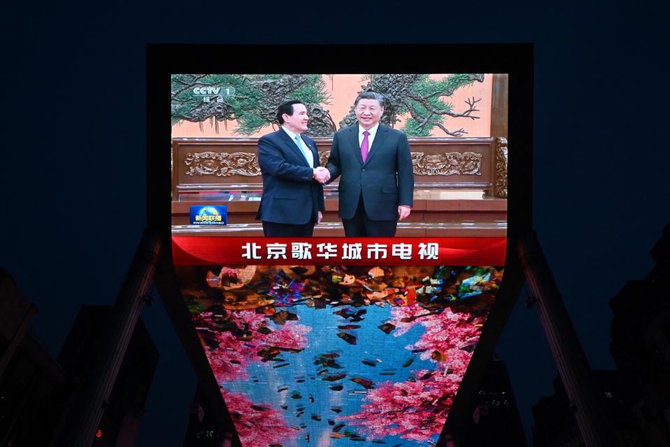 TOPSHOT - A large screen shows news coverage of Chinese President Xi Jinping (R) meeting former Taiwan president Ma Ying-jeou in Beijing on April 10, 2024. (Photo by GREG BAKER / AFP) (Photo by GREG BAKER/AFP via Getty Images)