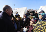 Turkey's President Recep Tayyip Erdogan speaks to survivors as he visits the city center destroyed by Monday earthquake in Kahramanmaras, southern Turkey, Wednesday, Feb. 8, 2023. Thinly stretched rescue teams worked through the night in Turkey and Syria, pulling more bodies from the rubble of thousands of buildings toppled by a catastrophic earthquake. The death toll rose Wednesday to more than 9,500, making the quake the deadliest in more than a decade. (Turkish Presidency via AP )