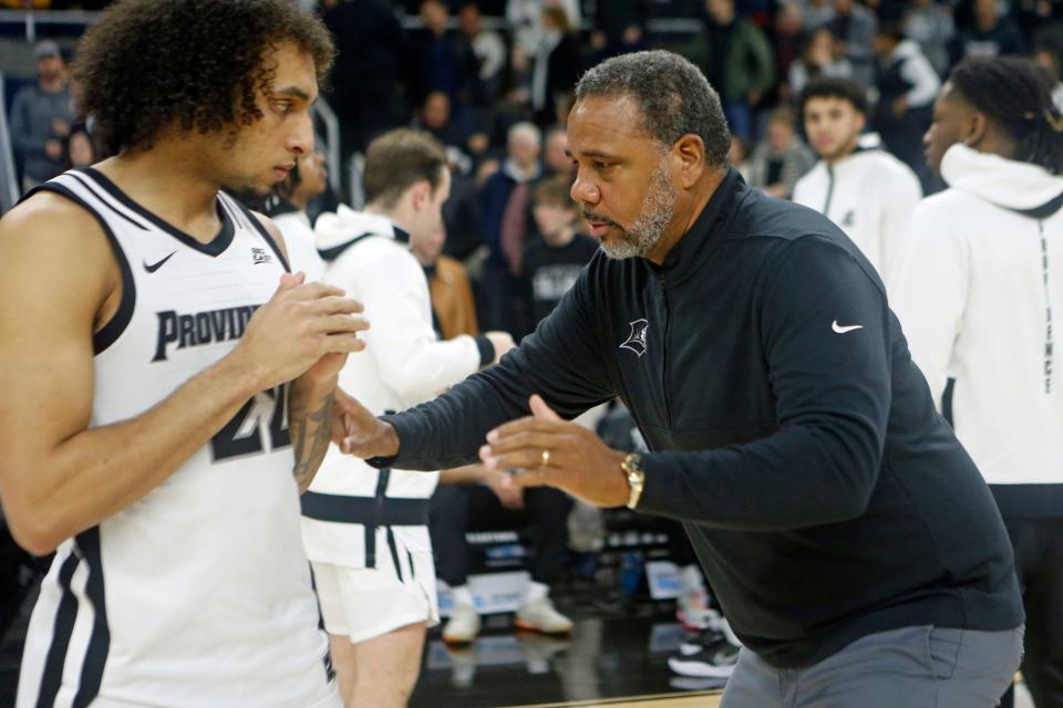 Devin Carter confers with coach Ed Cooley on the Providence sideline during a game this season.