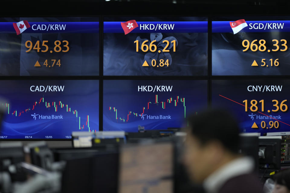 Currency traders watch computer monitors near the screens showing the foreign exchange rates at a foreign exchange dealing room in Seoul, South Korea, Wednesday, Nov. 22, 2023. (AP Photo/Lee Jin-man)