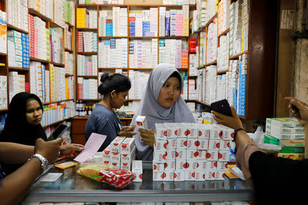 A shopkeeper prepares medicines to sell at a wholesale market in Jakarta, Indonesia, February 15, 2019. REUTERS/Willy Kurniawan