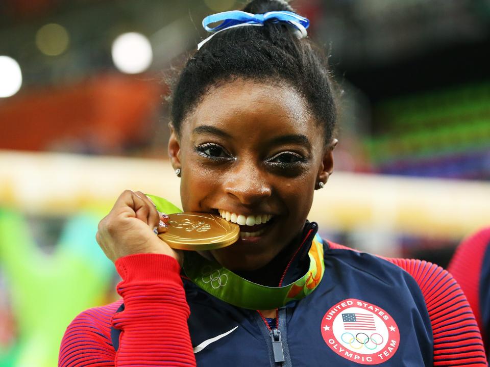 Gold medalist Simone Biles of the United States poses for photographs after the medal ceremony for the Women's Individual All Around on Day 6 of the 2016 Rio Olympics at Rio Olympic Arena on August 11, 2016 in Rio de Janeiro, Brazil.