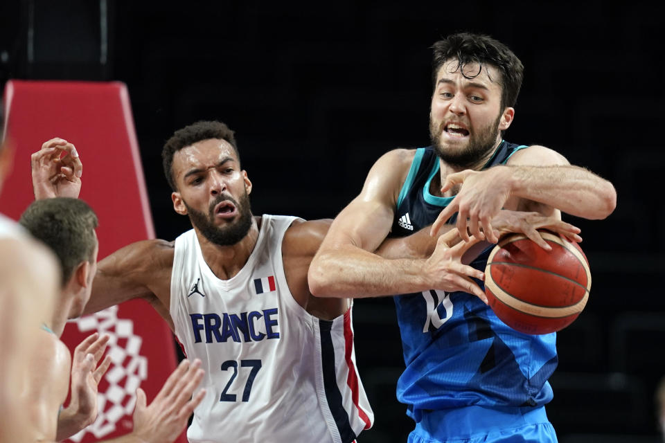 France's Rudy Gobert (27) fights for a rebound with Slovenia's Mike Tobey (10) during a men's basketball semifinal round game at the 2020 Summer Olympics, Thursday, Aug. 5, 2021, in Saitama, Japan. (AP Photo/Charlie Neibergall)