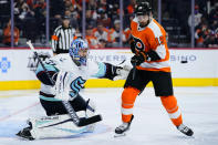 Seattle Kraken's Philipp Grubauer, left, blocks a shot as Philadelphia Flyers' Derick Brassard screens during the second period of an NHL hockey game, Monday, Oct. 18, 2021, in Philadelphia. (AP Photo/Matt Slocum)