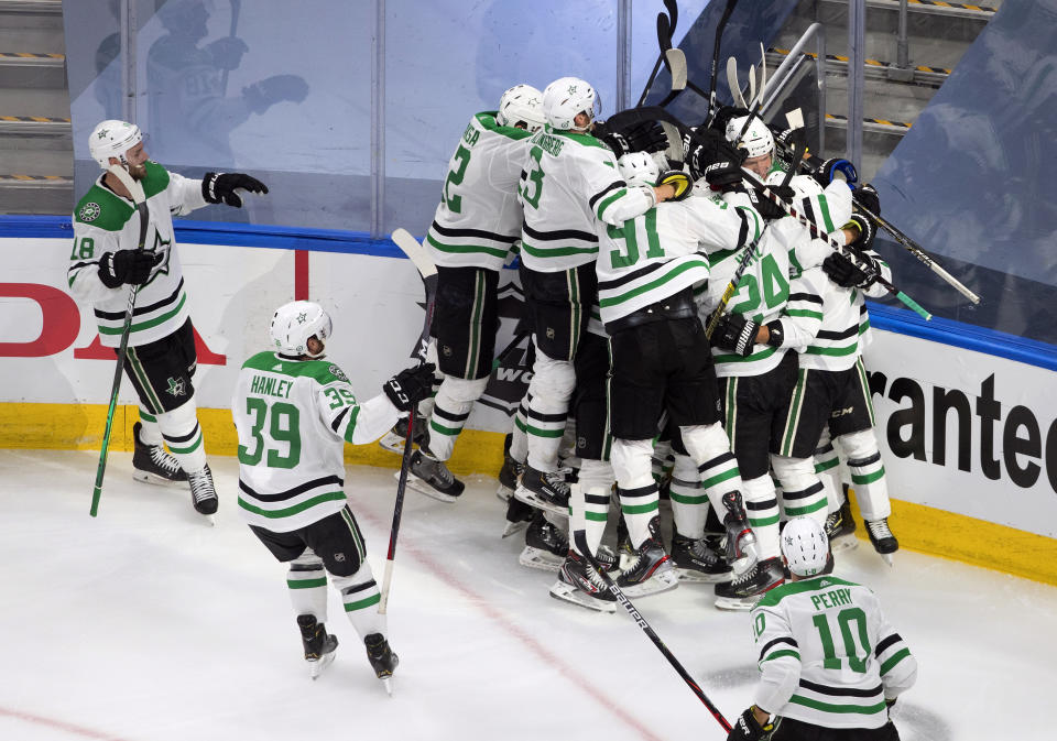 Dallas Stars celebrate their win over the Colorado Avalanche during overtime NHL Western Conference Stanley Cup playoff game action in Edmonton, Alberta, Friday, Sept. 4, 2020. (Jason Franson/The Canadian Press via AP)