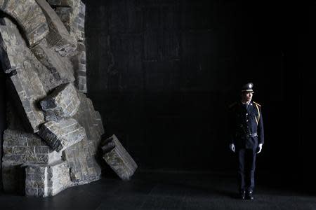 A security guard stands guard inside the Memorial Hall at the Nanjing Massacre Museum during a reporting trip, in Nanjing, Jiangsu province February 19, 2014. REUTERS/Aly Song