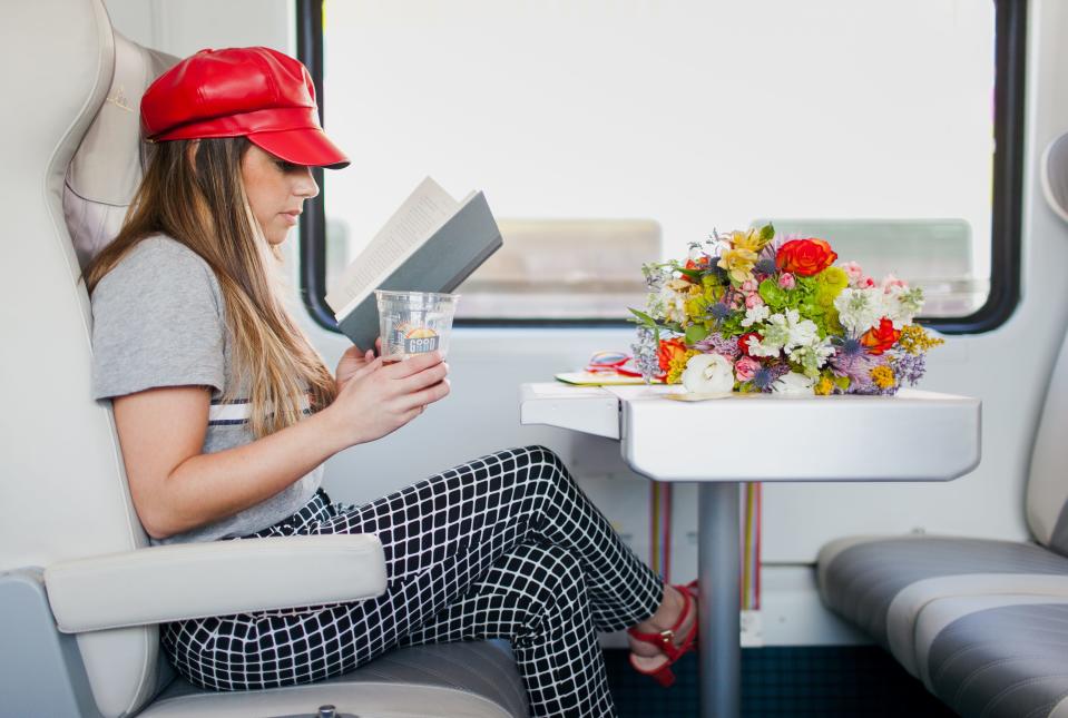 This Brightline image depicts a passenger riding in a train on the future Orlando-to-South Florida rail route.