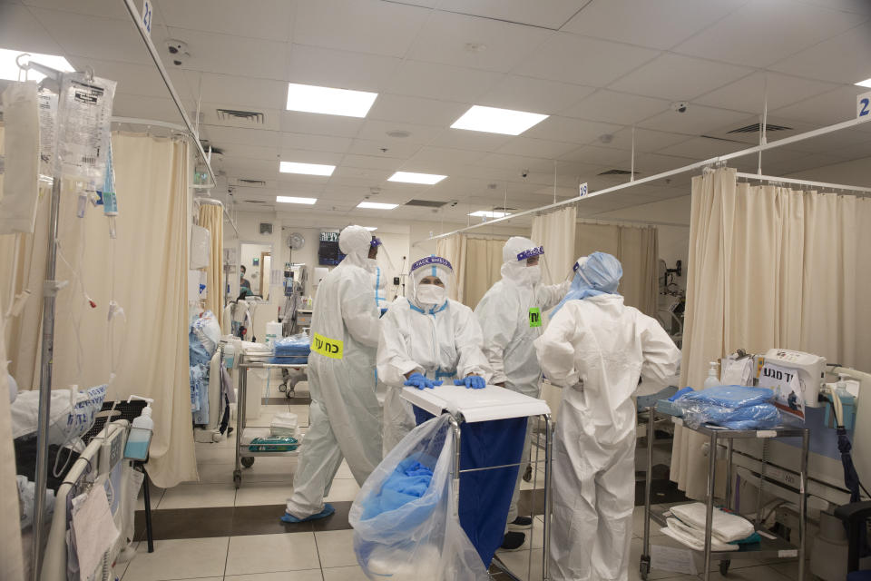 Medical professionals in protective equipment work in the coronavirus ward at the Shaare Zedek Medical Centerl in Jerusalem, Tuesday, Aug. 31, 2021. (AP Photo/Maya Alleruzzo)