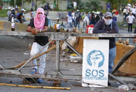 Demonstrators man a barricade after clashes broke out while the Constituent Assembly election was being carried out in Caracas, Venezuela, July 30, 2017. REUTERS/Christian Veron