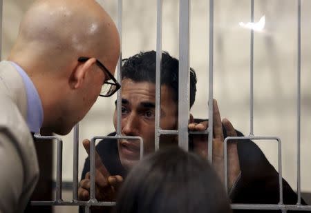 Mohammed Ali Malek (R) speaks with his lawyer Massimo Ferrante at Catania's tribunal, April 24, 2015. REUTERS/Antonio Parrinello