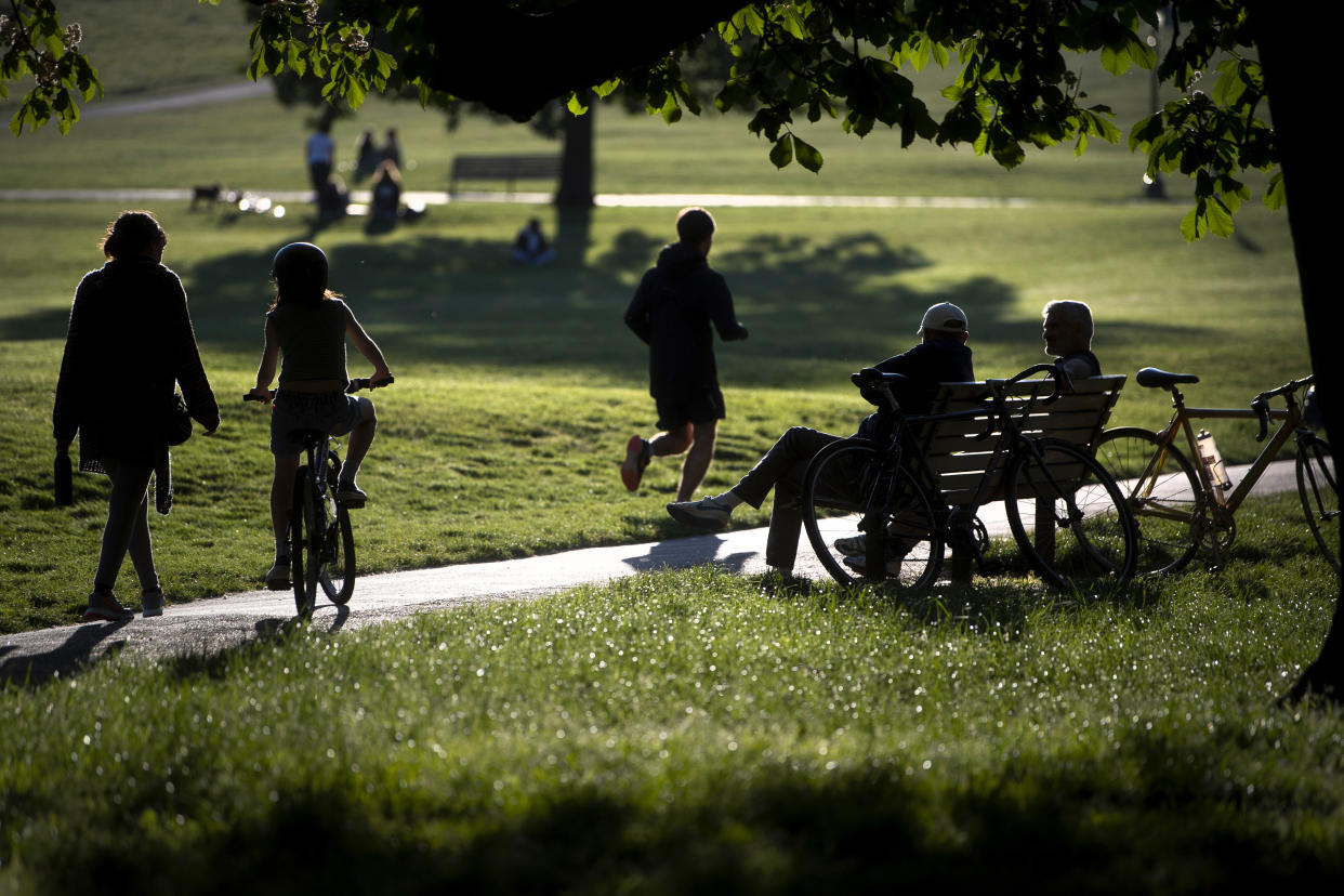 People relax and exercise in Primrose Hill park in central London, as the UK continues in lockdown to help curb the spread of the coronavirus.