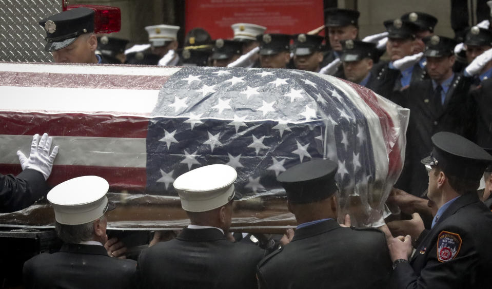 Firefighters hoist the casket of U.S. Marine Corps Staff Sergeant and FDNY Firefighter Christopher Slutman on to a firetruck, after funeral service at St. Thomas Episcopal Church, Friday April 26, 2019, in New York. (AP Photo/Bebeto Matthews)