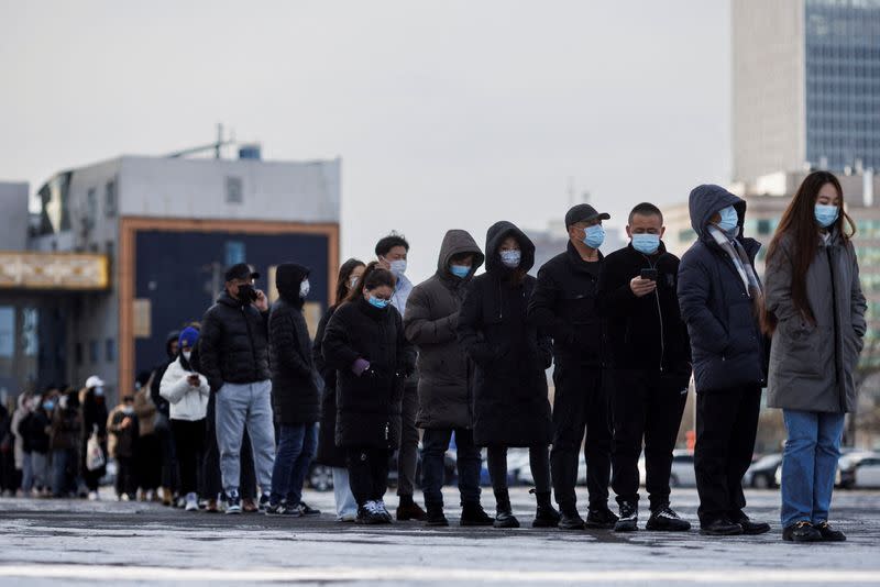 FILE PHOTO: People line up to get throat swab test at a temporary COVID-19 testing center as the coronavirus disease (COVID-19) continues in Beijing