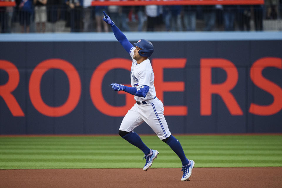 Toronto Blue Jays' George Springer celebrates after hitting a solo home run against the Tampa Bay Rays during the first inning of a baseball game Friday, April 14, 2023, in Toronto. (Christopher Katsarov/The Canadian Press via AP)
