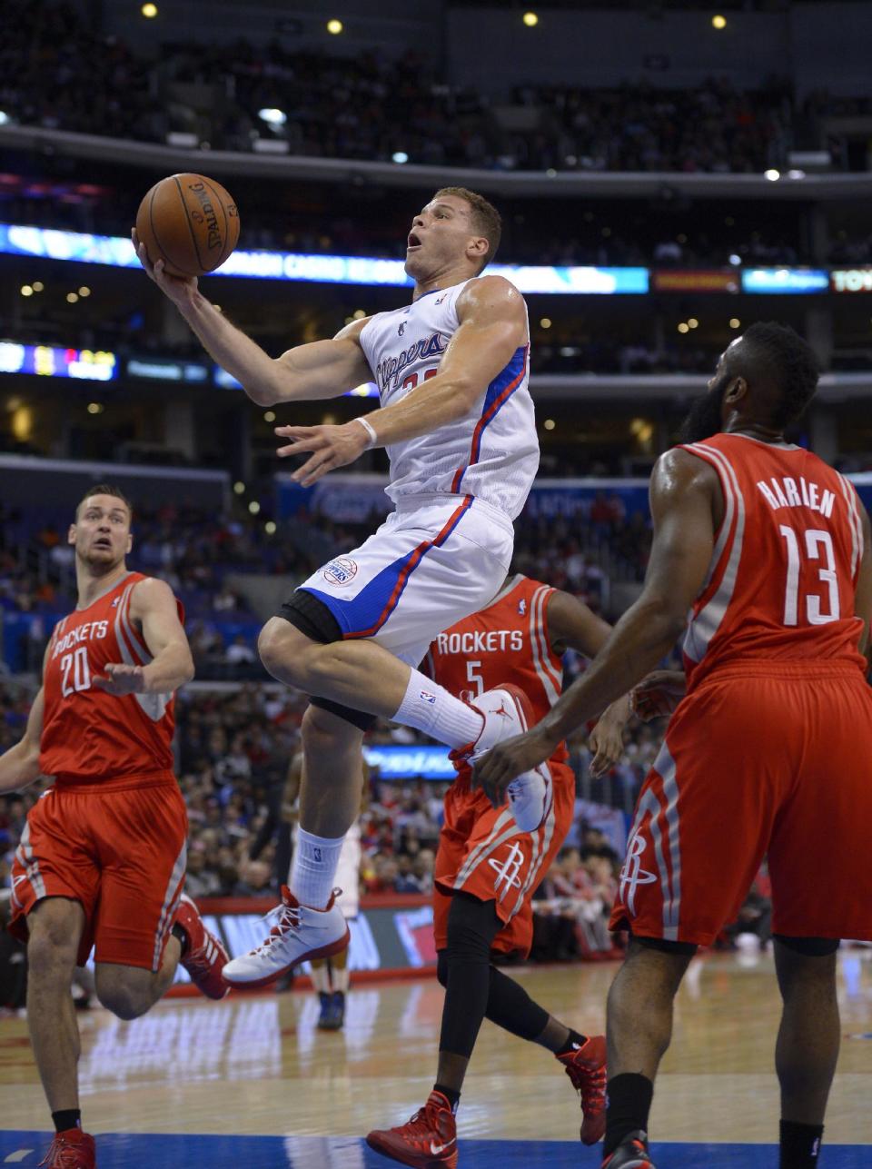 Los Angeles Clippers forward Blake Griffin, second from left, goes up for a shot as Houston Rockets forward Donatas Motiejunas, left, of Poland, forward Jordan Hamilton, second from right, and guard James Harden defend during the first half of an NBA basketball game, Wednesday, Feb. 26, 2014, in Los Angeles. (AP Photo/Mark J. Terrill)