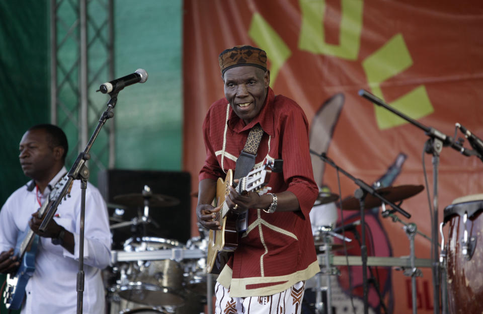 FILE - In this Sunday, Nov. 6, 2011 file photo, Zimbabwean music superstar and U.N. goodwill ambassador Oliver Mtukudzi, center, performs at a music festival held in Karen on the outskirts of Nairobi, Kenya. Zimbabwean musician and world music star Oliver Mtukudzi dies in Harare at age 66, it was announced Wednesday, Jan. 23, 2019. (AP Photo/Ben Curtis, file)