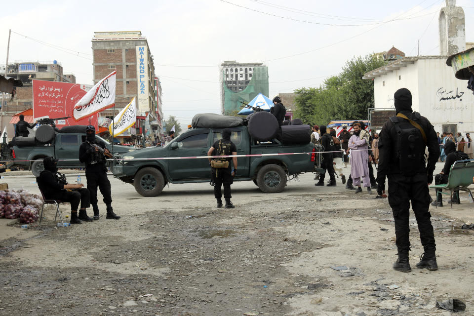 Taliban fighters stand guard in the site of explosion through a hotel in the city of Khost province eastern of Afghanistan, Monday, Aug. 14, 2023. An explosion ripped through the hotel in Afghanistan's eastern province, killing at least three people and wounding seven others, police said. (AP Photo/Saifullah Zahir)