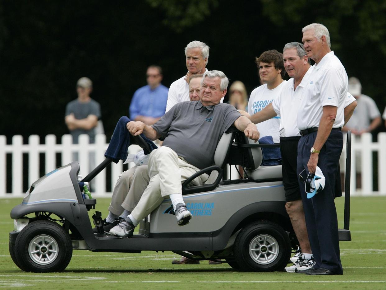 Carolina Panthers founding owner Jerry Richardson (seated) takes in a training camp practice at Wofford College.