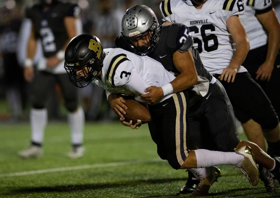 Reitz’s Levi Oxley (35) tackles Boonville's Grant Davis (3) as the Reitz Panthers play the Boonville Pioneers at the Reitz Bowl in Evansville, Ind., Friday, Oct. 20, 2023.
