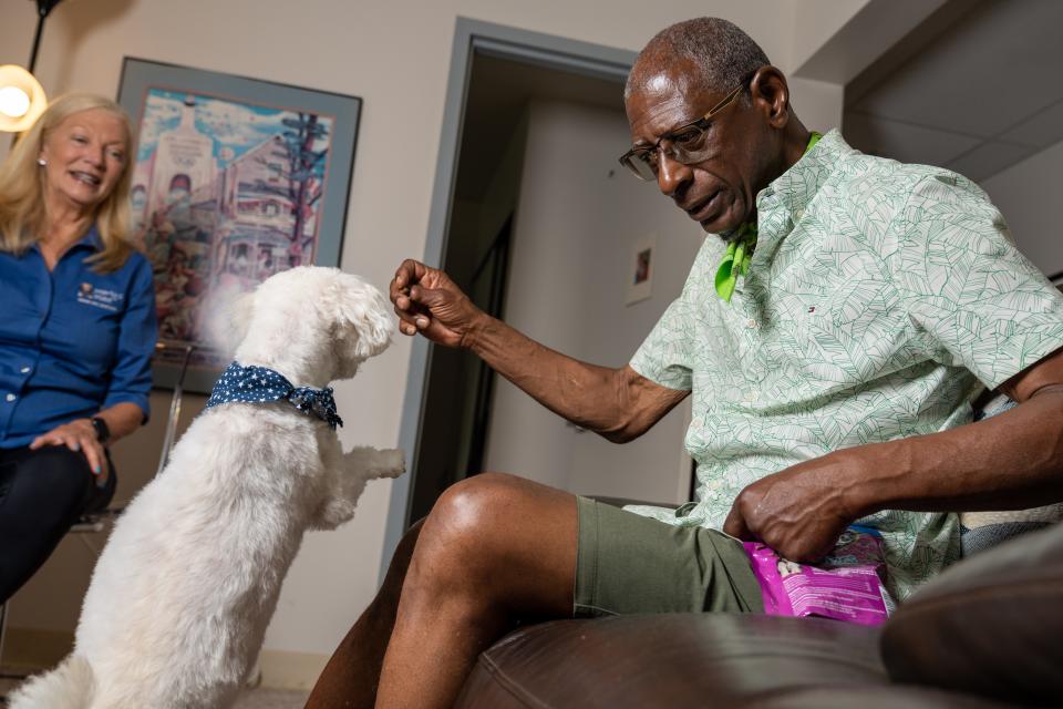 Max Hill Jr. with Prada, his 15-year-old Maltese mix with a heart condition, and Marty's Place Senior Pet Assistance Program Coordinator Debbie Williamson.