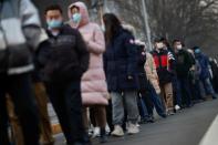 People line up to get their nucleic acid test at a mass testing site following the outbreak of the coronavirus disease (COVID-19) in Beijing