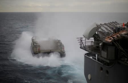 A U.S. Navy Landing Craft Air Cushion (LCAC) appears from the stern of the USS Bonhomme Richard amphibious assault ship during events marking the start of Talisman Saber 2017, a biennial joint military exercise between the United States and Australia, off the coast of Sydney, Australia July 29, 2017. REUTERS/Jason Reed