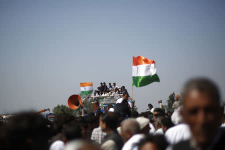 Demonstrators from the Jat community sit on top of a truck as they block the Delhi-Haryana national highway during a protest at Sampla village in Haryana, India, February 22, 2016. REUTERS/Adnan Abidi