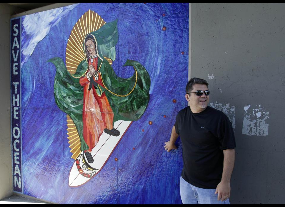 The image of the Virgin of Guadalupe on a surfboard is a popular attraction in Encinitas, Calif. was installed recently by disguised artists under a train bridge. 