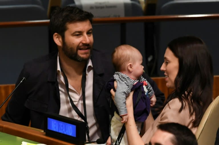 Ardern, right, hold her daughter at the UN General Assembly, as her partner looks on