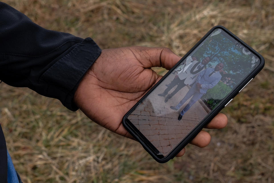 Ally shows a picture of himself and Abdul from Abdul’s wedding day.