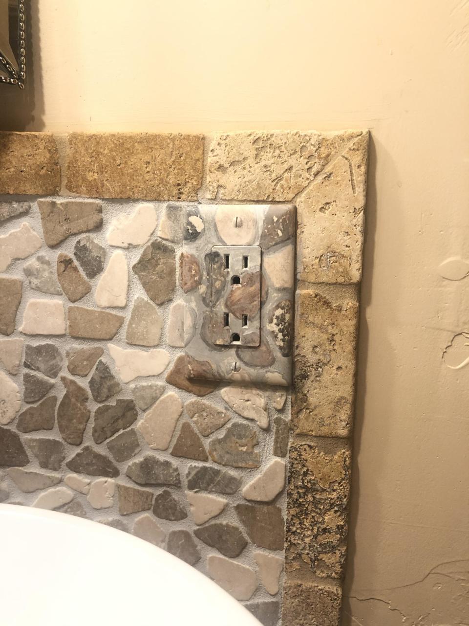 outlet painted like the stone backdrop