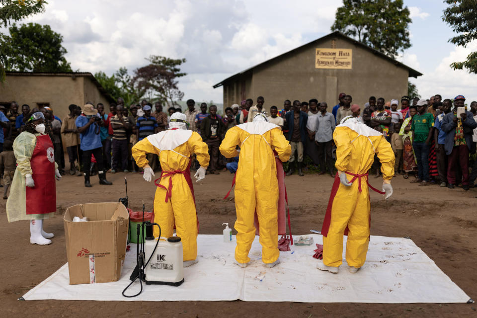 Red Cross workers don PPE prior to burying a 3-year-old boy suspected of dying from Ebola on October 13, 2022, in Mubende, Uganda. / Credit: Luke Dray / Getty Images