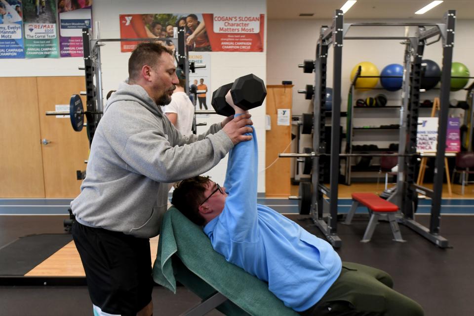 Jeff Dempsey works with son Jake, 15, a Tuslaw freshman, on training at Schalmo Family YMCA in Canal Fulton.