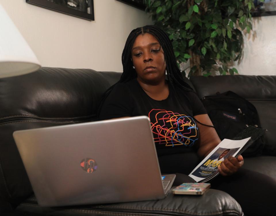 Jemika Hall, checks on her nonprofit's Facebook group while at her home in Beacon on November 15, 2021. After Hall's son was murdered she decided to start her nonprofit, MARC's Friends in September, 2020 to provide a support group for people in the community who have suffered trauma from violence.   